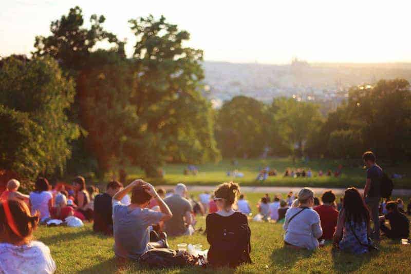 A crowd of picnickers shows the social community that in Catholic social teaching is the end of common good.