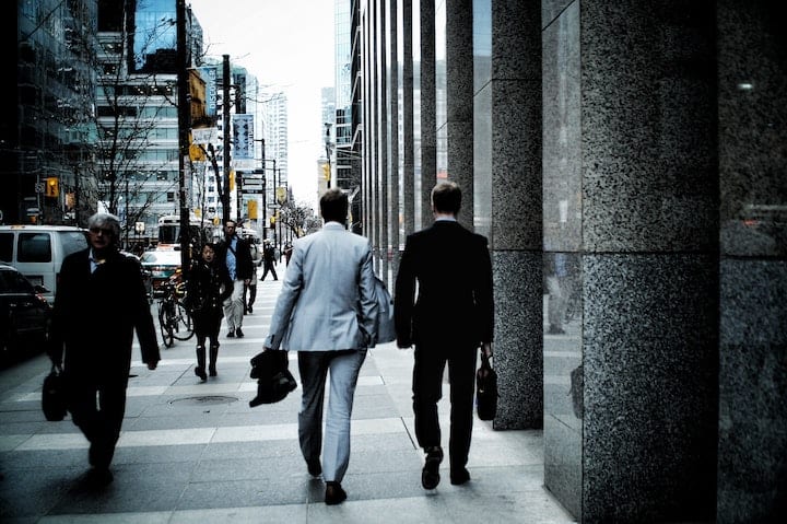 work-street-downtown-city-businessman-economy-cummute-walk-career Two businessmen walking to work in a city downtown.